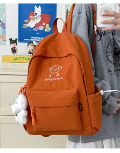 Cute orange cartoon puppy backpack for daily school and campus use with convenient pockets.