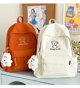 Japanese ins style cute cartoon dog canvas backpack with plush pendant, stylish student school bag.