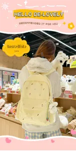 Detailed view of cute canvas school backpack with adorable cake embroidery and plush bear pendant.
