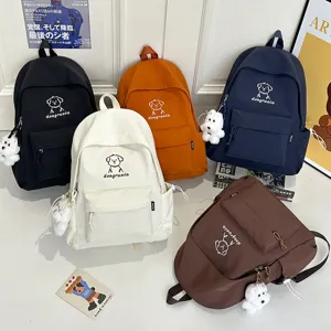Cute cartoon dog canvas backpack for teens, stylish daily school bag with plush pendant.