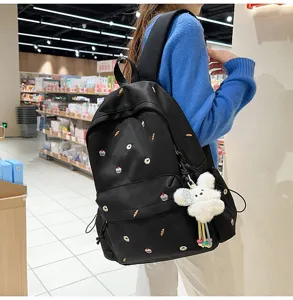 Black canvas backpack embroidered with cute bread and cake patterns, casual school bag for women.