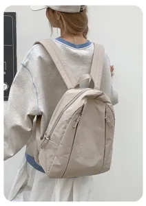 Detail shot of a minimalist beige casual backpack, perfect for daily travel and college students.