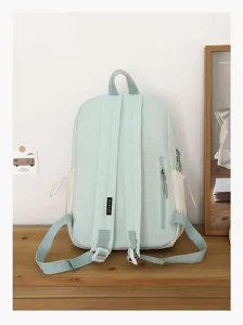Vista dettagliata dello zaino casual verde chiaro e bianco con pratica tasca con zip.