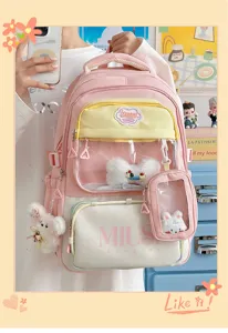 Detail view of pink student backpack with clear front pocket and cute plushie charms