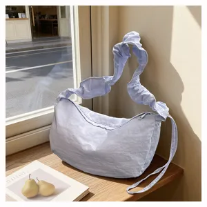 Light blue nylon ruched shoulder bag, casual hobo dumpling bag with zipper and stylish strap.