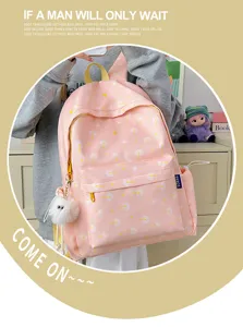 Sweet pink dandelion print backpack detail showing cute star pattern and fluffy keychain accessory.