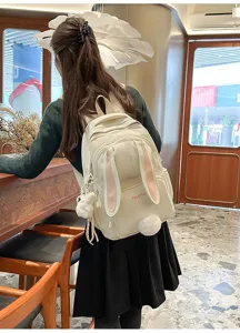 Detailed view of the cute bunny ears backpack worn by a student, showing the back design.