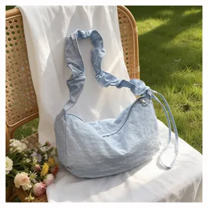Light blue nylon pleated crossbody bag, casual single-shoulder dumpling bag detail.