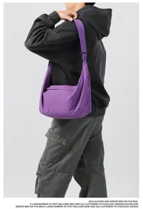 Minimalist purple nylon crossbody shoulder bag, casual commuter travel bag detail view.