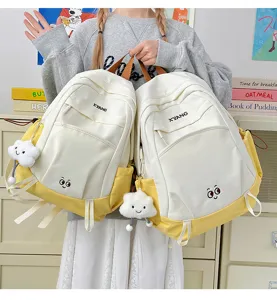 Detailed view of the dual colorblock casual backpacks showcasing cute cloud pendant and pockets.
