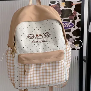 Detail view of the cute Japanese style beige polka dot and gingham backpack, front embroidered.
