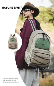 Outdoor casual backpack detail shot showing multi-pocket design and elastic bungee cords.