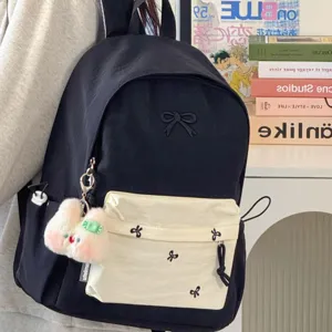 Japanese ins style black canvas school backpack with cute bow embroidery and plush bunny pendant.