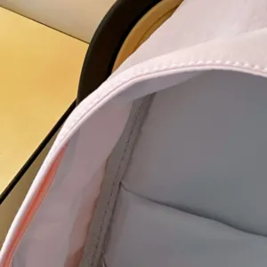 Detail view of the backpack interior lining and neat edge stitching, minimalist style design.