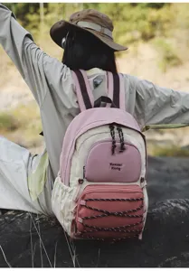 Stylish casual outdoor backpack in pink and beige, featuring multi-pocket design for daily travel.