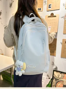 Casual light blue backpack for women, large capacity travel school bag with cute pendant.