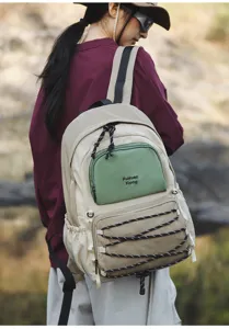 Outdoor casual backpack detail showing the multi-pocket design and elastic bungee cord.