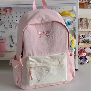 Pink cute school backpack detail featuring sweet bow embroidery in a cozy room aesthetic.