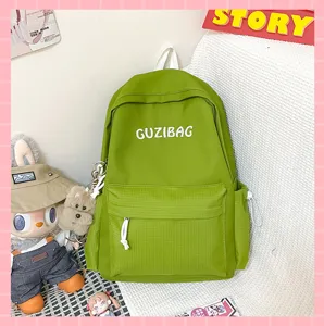 Green casual canvas backpack detail, featuring front embroidery and side pockets, stylish look.