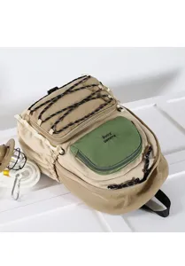 Close-up view of the casual outdoor backpack detailing the front green pocket and bungee cords.