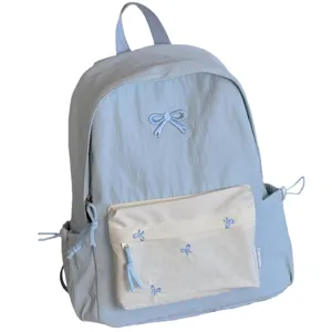 Japanese style cute bow embroidery school backpack for women, casual light blue travel daypack.
