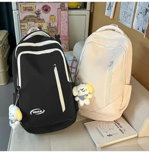 Detailed view of large capacity casual canvas backpack with cute puppy pendant.