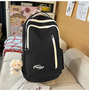 Large capacity black student backpack with white zipper trim and cute puppy plush pendant.