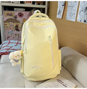 Large capacity yellow backpack for school, travel, and daily use with cute puppy pendant.