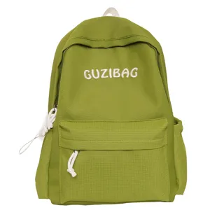 Green casual canvas backpack for women, simple aesthetic school bookbag with front pocket.