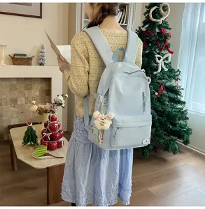 Casual light blue school backpack for women, cute sweet style travel daypack with bear pendant.