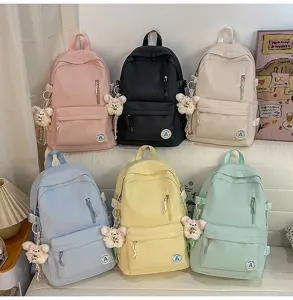 Casual canvas school backpack for teen girls, multi-color candy style book bag with cute bear pendant.