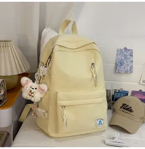 Korean style canvas backpack for women, cute school bag with front pocket and sweet bear pendant.