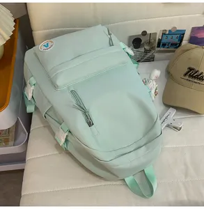Casual light green canvas school backpack for women and students with multiple storage pockets.