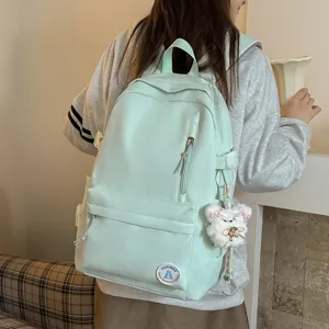 Mint green campus style school backpack for women, cute plush bear pendant, large capacity.