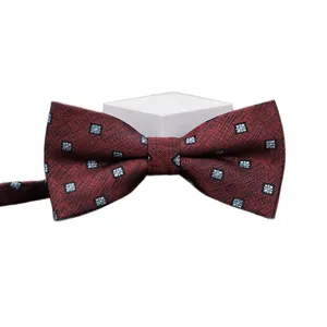 Burgundy men's bow tie with blue geometric pattern for wedding and formal suit wear.