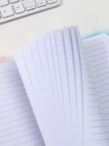 Close-up detail shot of lined paper pages inside a cute pastel fluffy notebook cover.