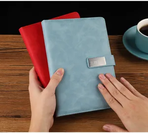 A5 leather notebook detail, metal magnetic clasp, business journal, office stationery.
