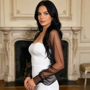 Black sheer mesh sleeves and white strapless dress detail showing exquisite fabric texture.