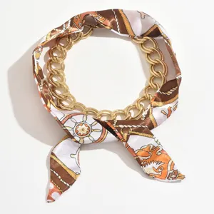 Elegant metal chain and silk scarf necklace, vintage baroque style jewelry accessory.