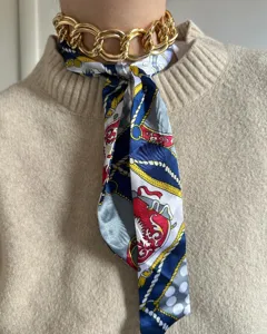 Chic gold chain choker necklace paired with printed silk scarf fashion jewelry accessory.