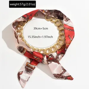 Detailed close-up view of the luxurious gold chain intertwined with red patterned silk scarf necklace.