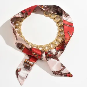 Close-up detail of the fashion chain silk scarf necklace, featuring red patterned fabric.