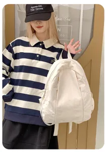 Casual minimalist white canvas backpack detail showcasing large capacity and stylish design.