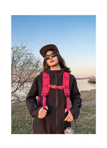 Outdoor hiking backpack detail view, ergonomic shoulder straps, durable pink travel design