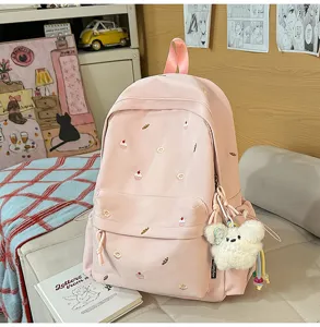 Cute pink canvas backpack for school girls with sweet embroidery and lovely fluffy bear keychain.