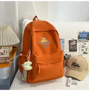 Korean style campus backpack for women, large capacity travel school bag with cute cartoon print.