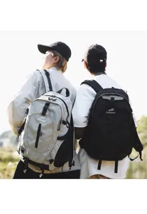 Outdoor backpack detail showing couple wearing large capacity hiking bags in natural scene.