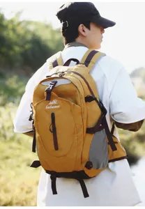 Detailed outdoor view of yellow hiking backpack showing multiple straps and compartments.