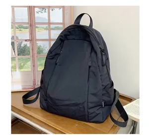 Detailed shot of casual black solid color backpack for women, daily travel student school bag.