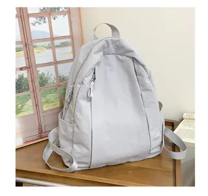 Minimalist light grey casual backpack for women, daily travel lightweight daypack bookbag.